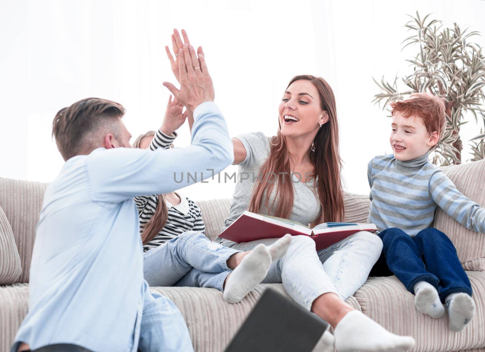 happy parents giving each other a high five.the concept of family life