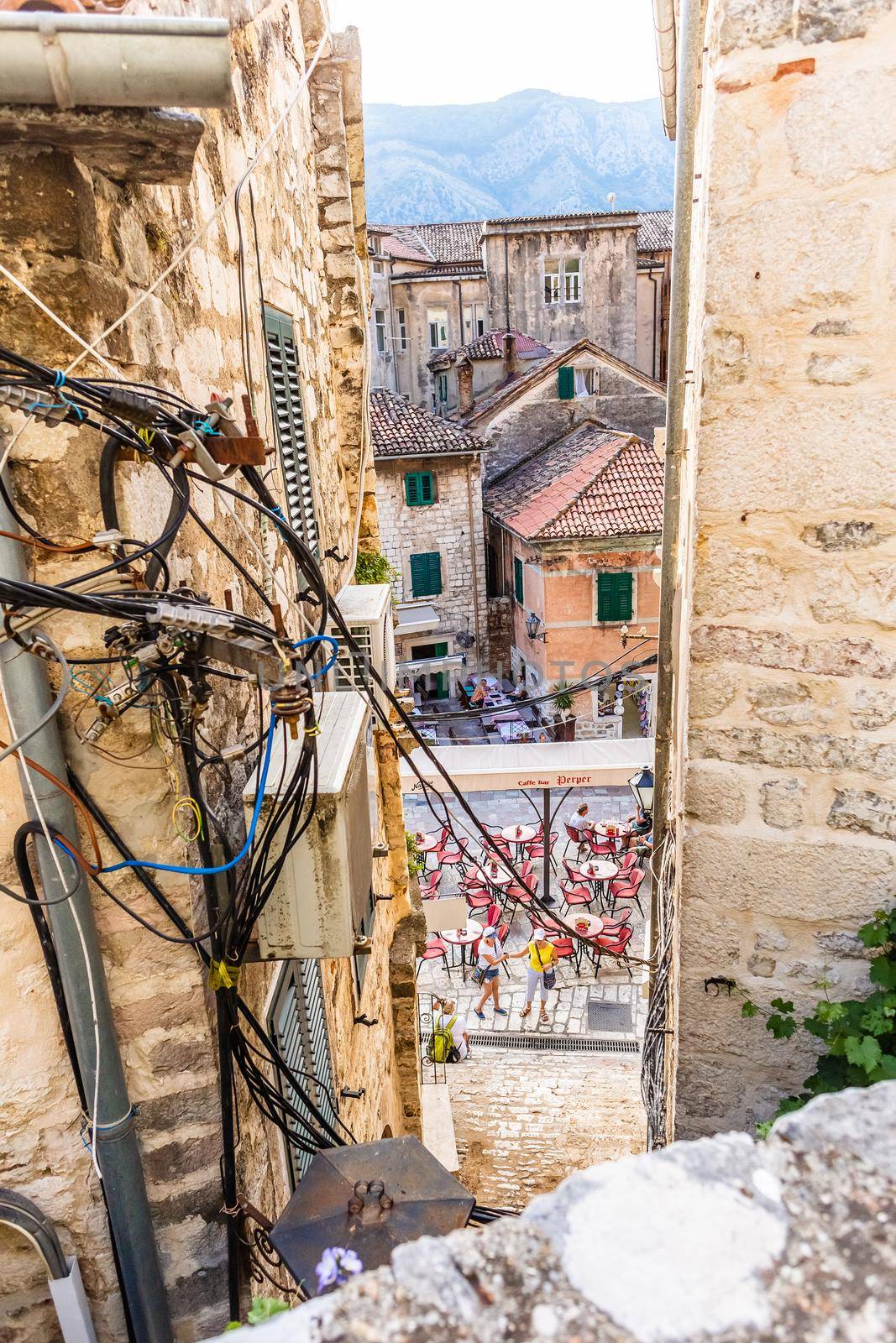 KOTOR, MONTENEGRO - September 16, 2019: Tangled wires and cables between old houses in Kotor city in Montenegro