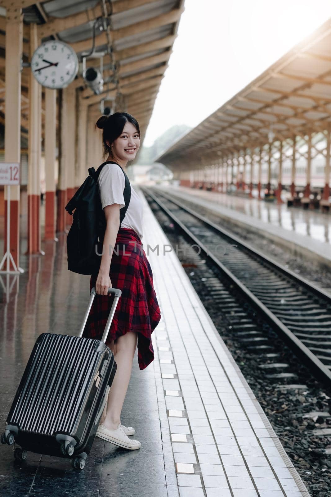 Summer, Travel, Vacation, Relax, A smiling female tourist looks at the train station for a summer vacation, travel concept by wichayada