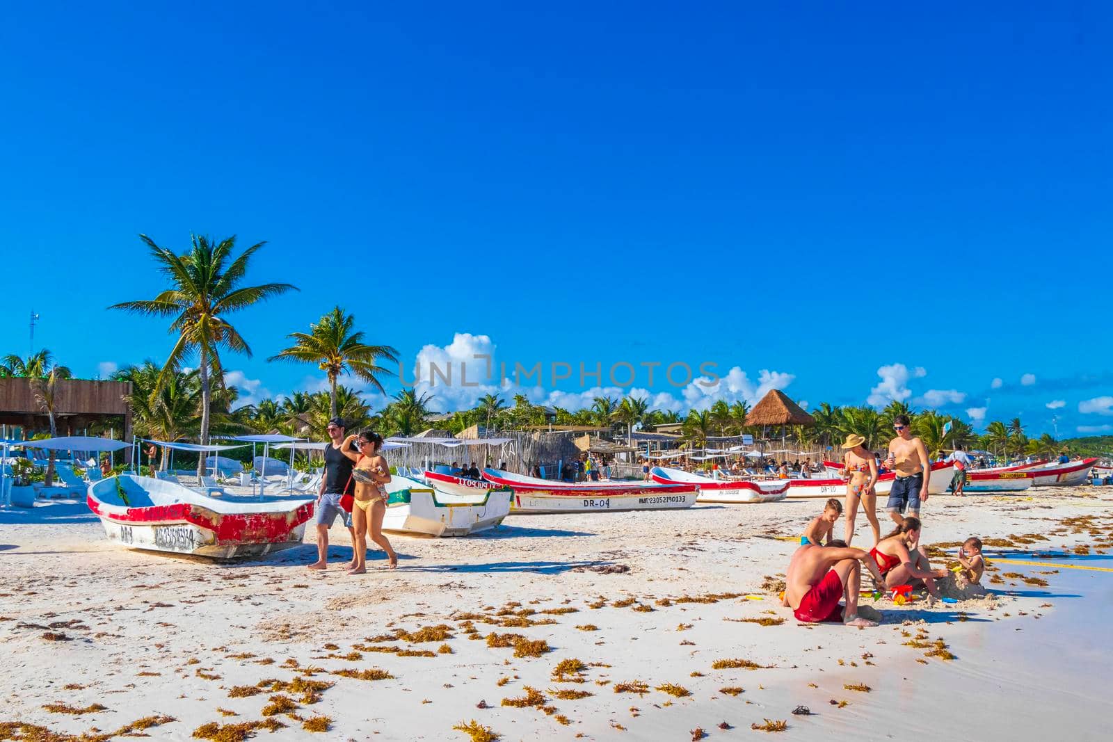 People boats caribbean coast and beach panorama view Tulum Mexico. by Arkadij