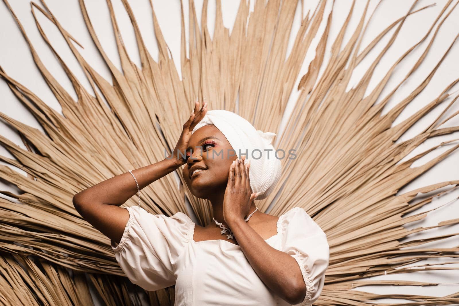 Portrait of black business lady on the dry leaves background. African model is posing in studio. by Rabizo