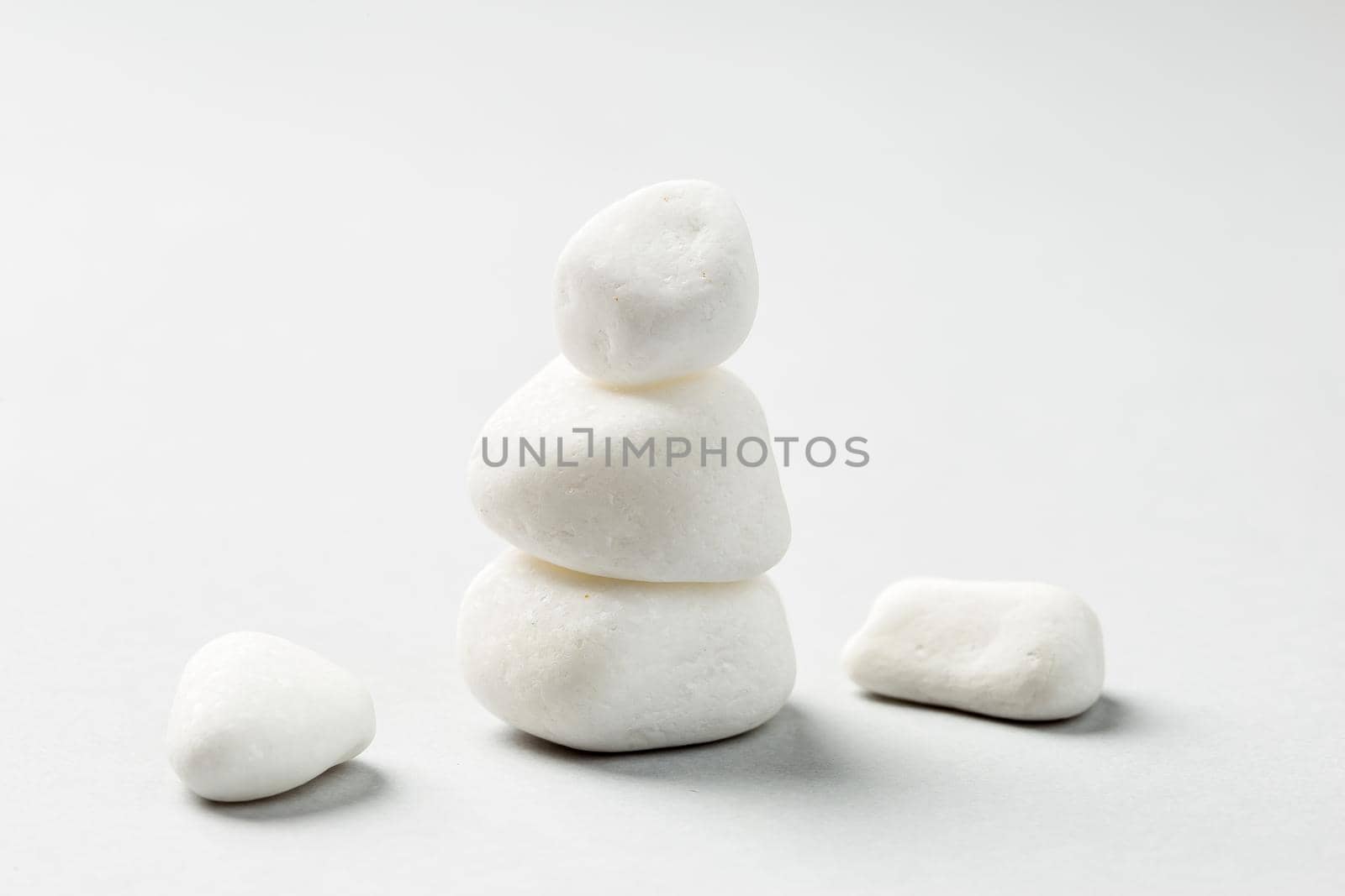 Balancing zen pebble stones on grey background  by Syvanych