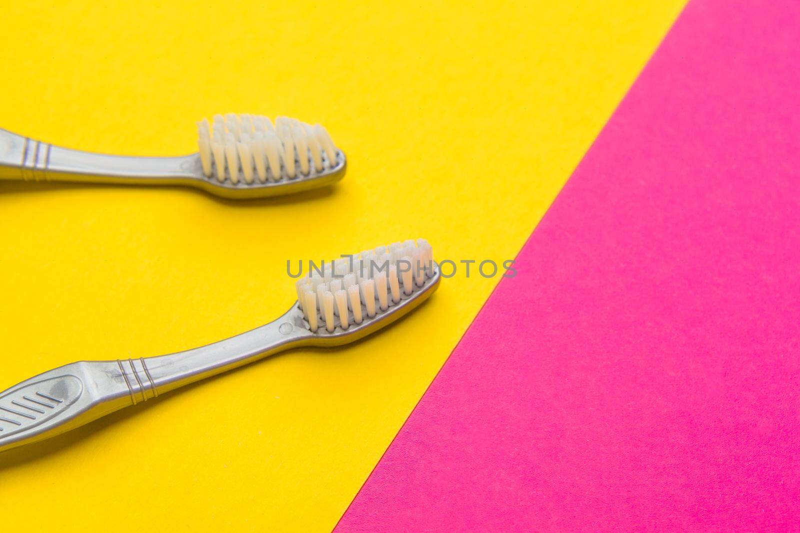 Flat lay composition with manual toothbrushes on color background, close up by Fabrikasimf