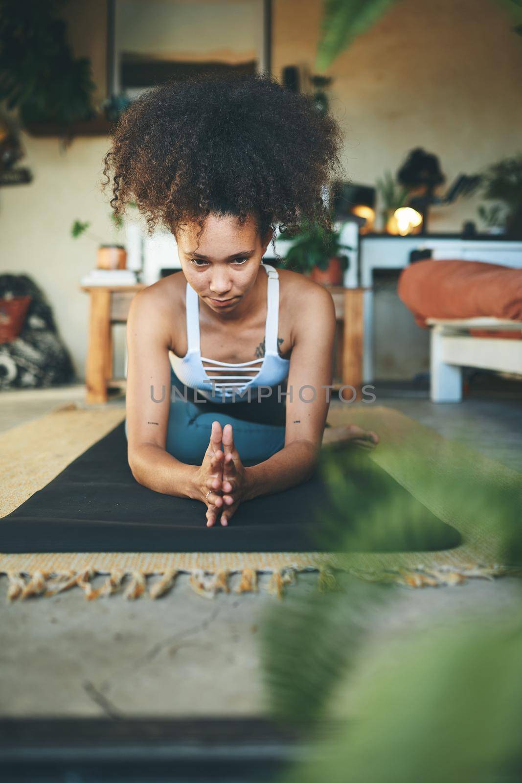 Shot of a young woman in plank position on her exercise mat - Stock Photo