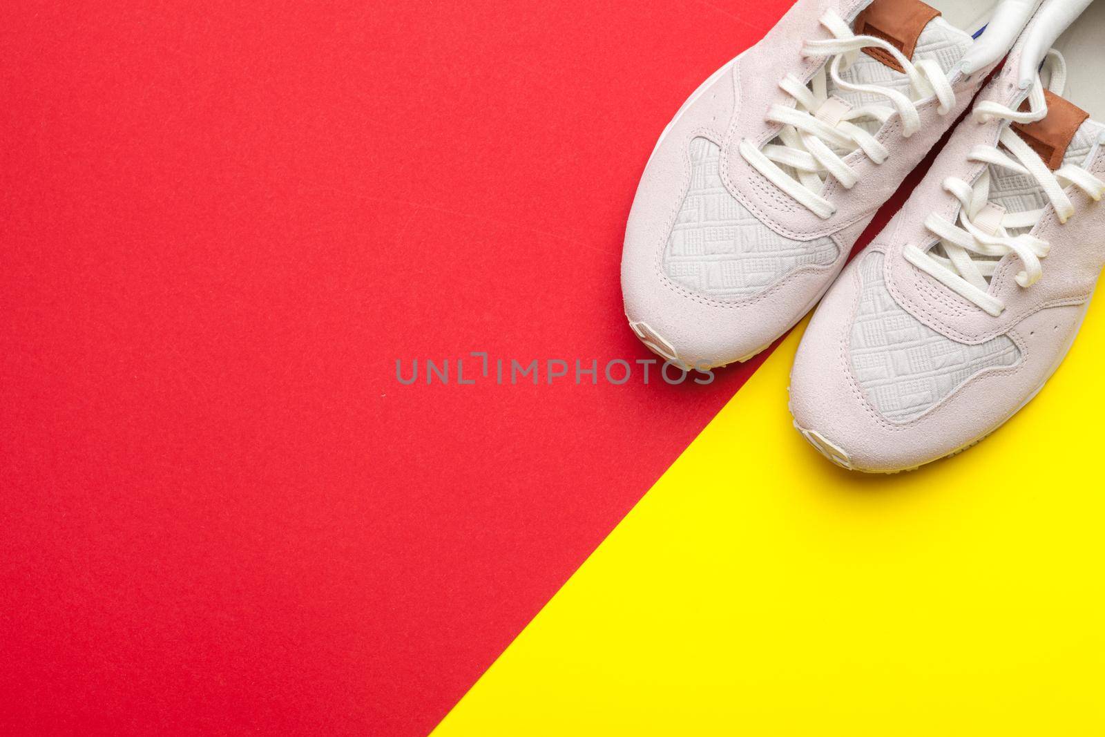 Pair of sport shoes on colorful background. New sneakers by Fabrikasimf