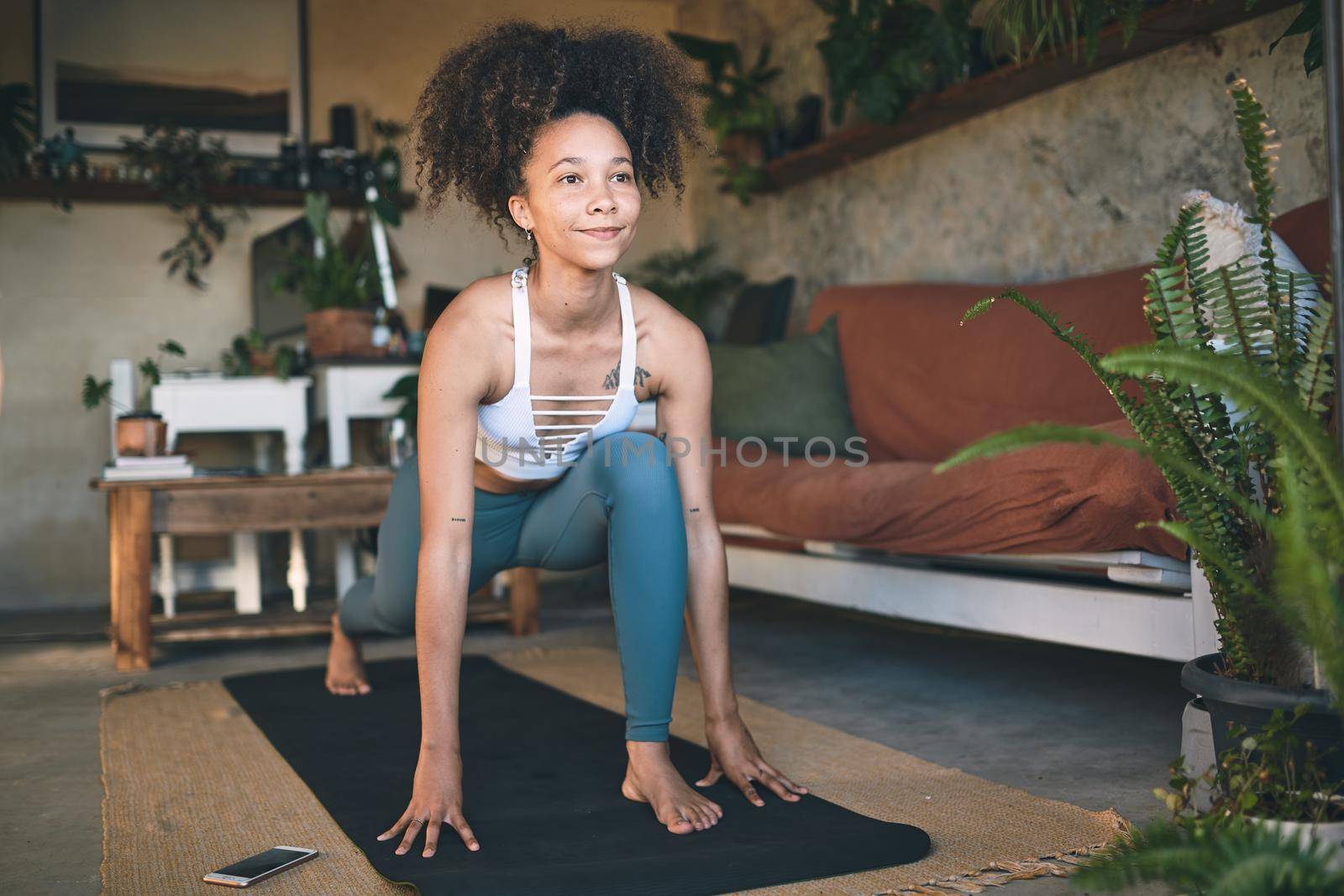 Shot of a young woman doing lunge exercise at home