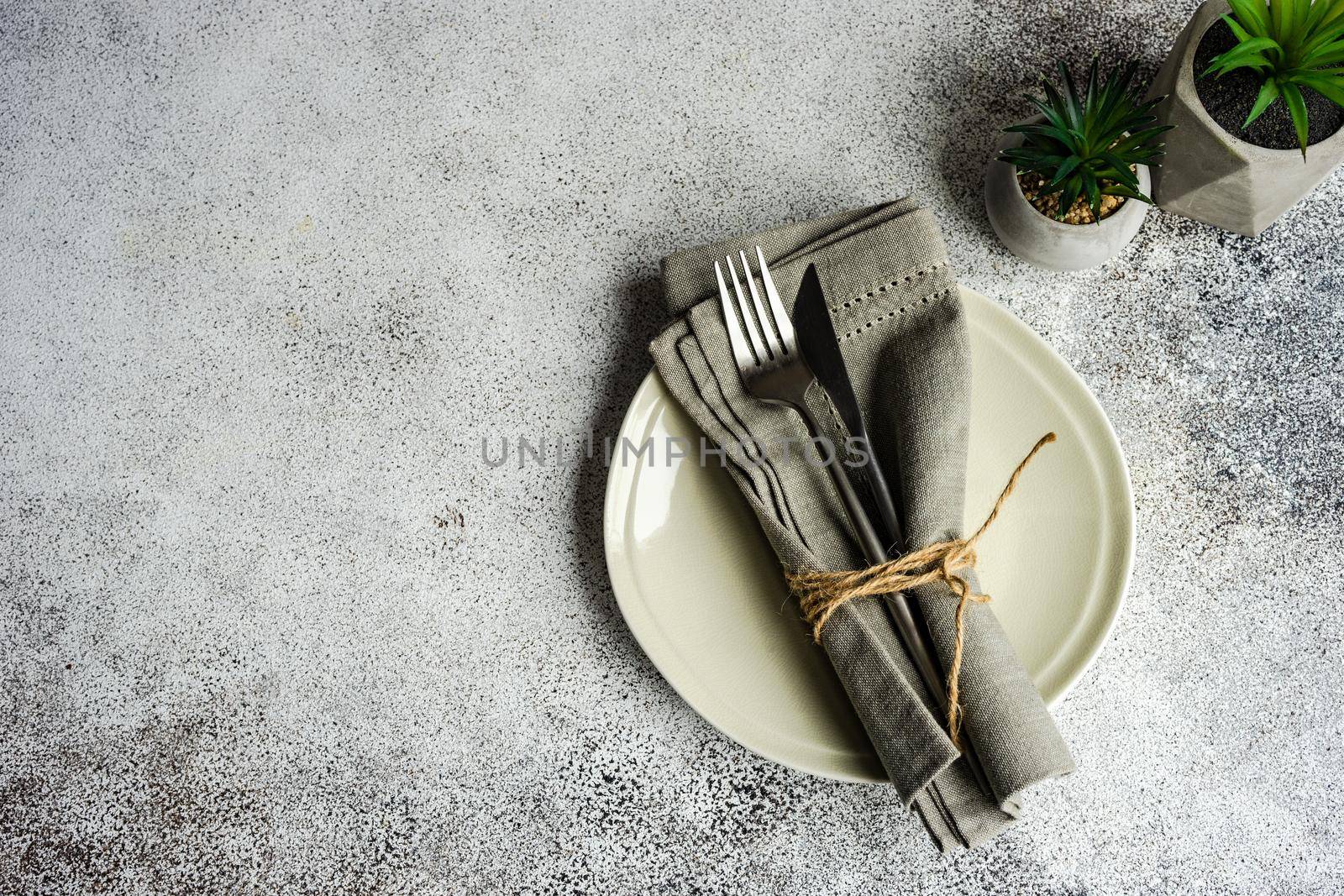 Table setting on concrete background by Elet