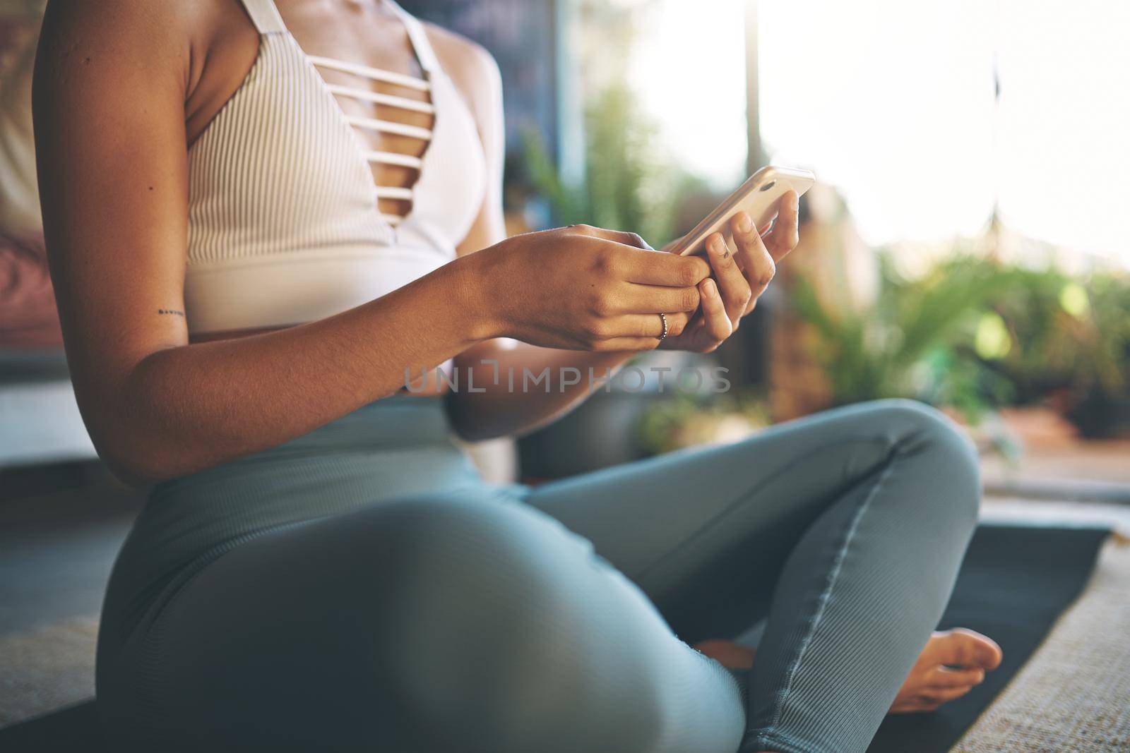 Cropped shot of a unrecognizable young woman browsing on her smartphone