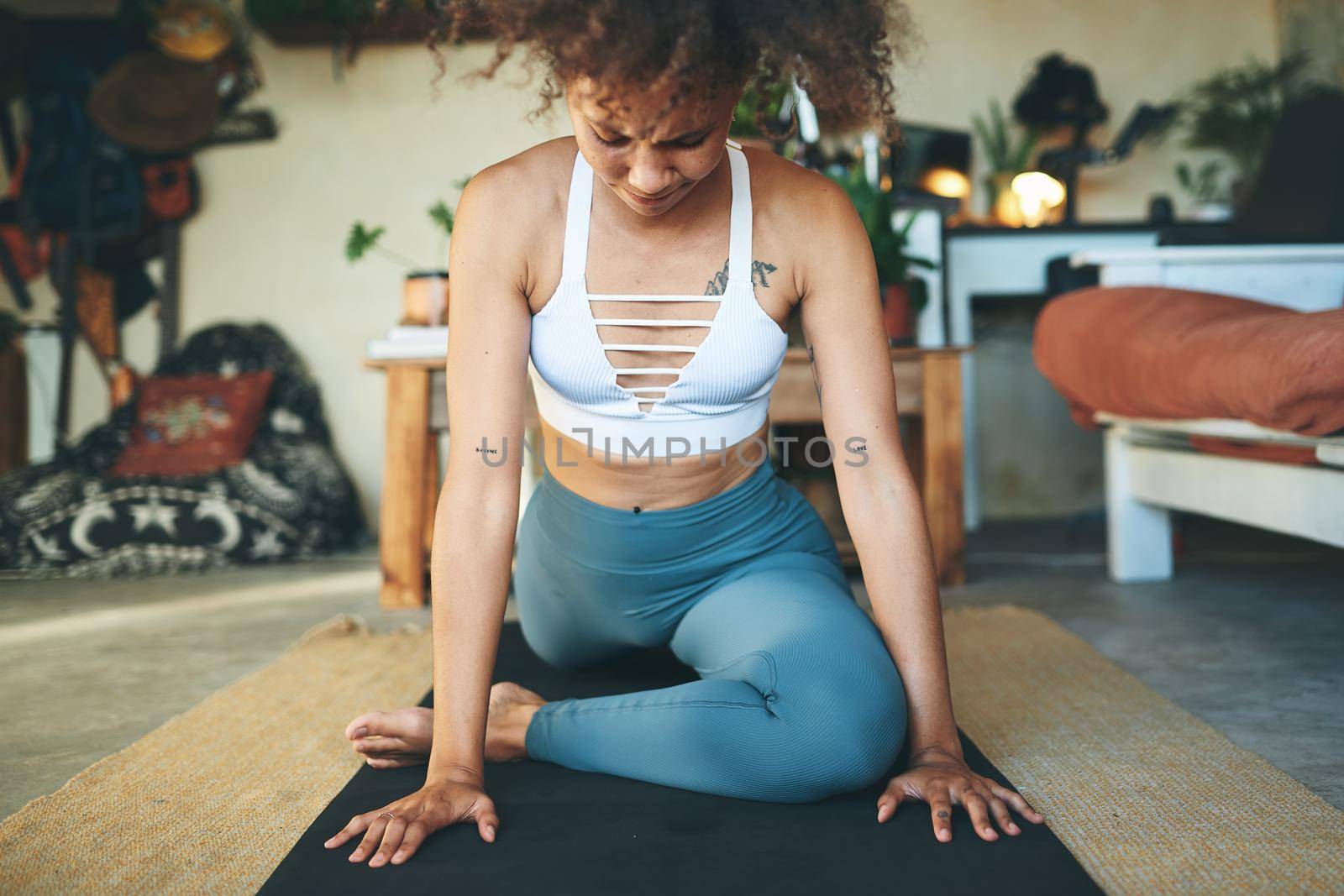 Shot of a woman doing yoga in her living room