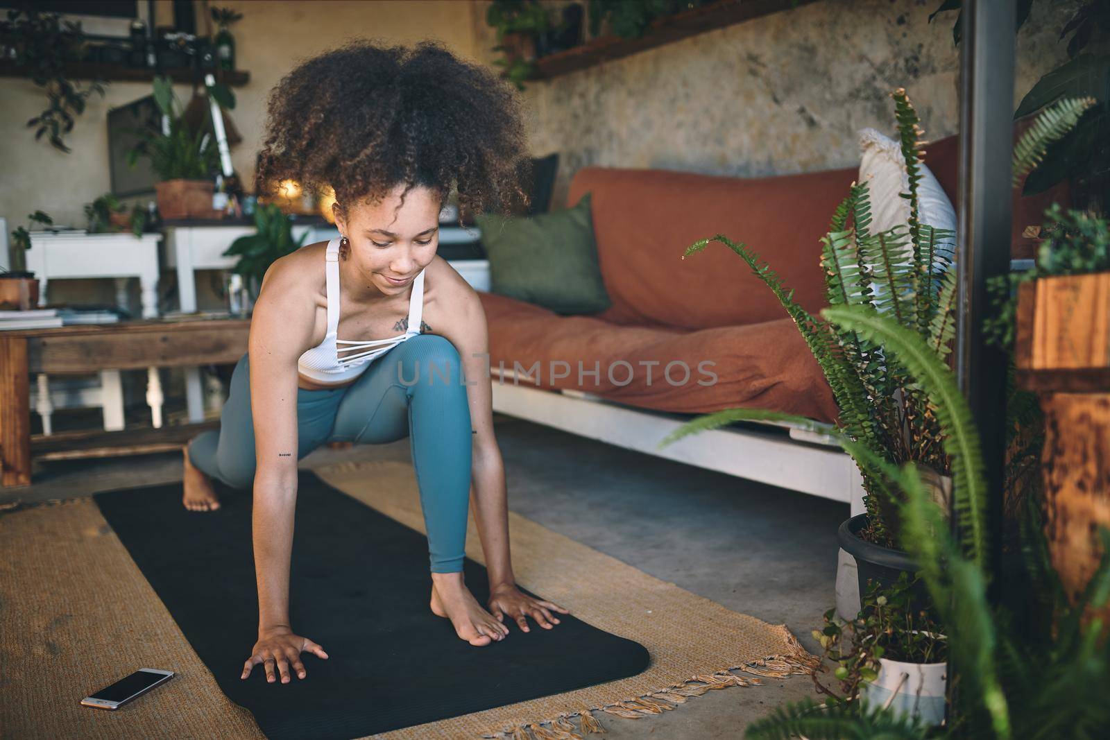 Shot of a young woman doing lunge exercise at home