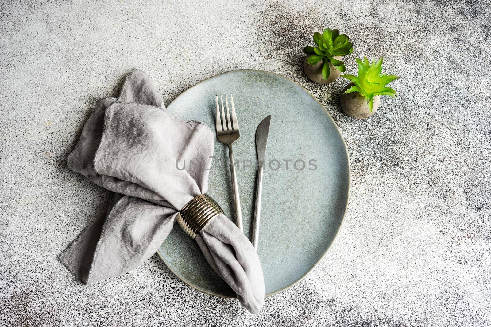 Table setting on concrete background by Elet