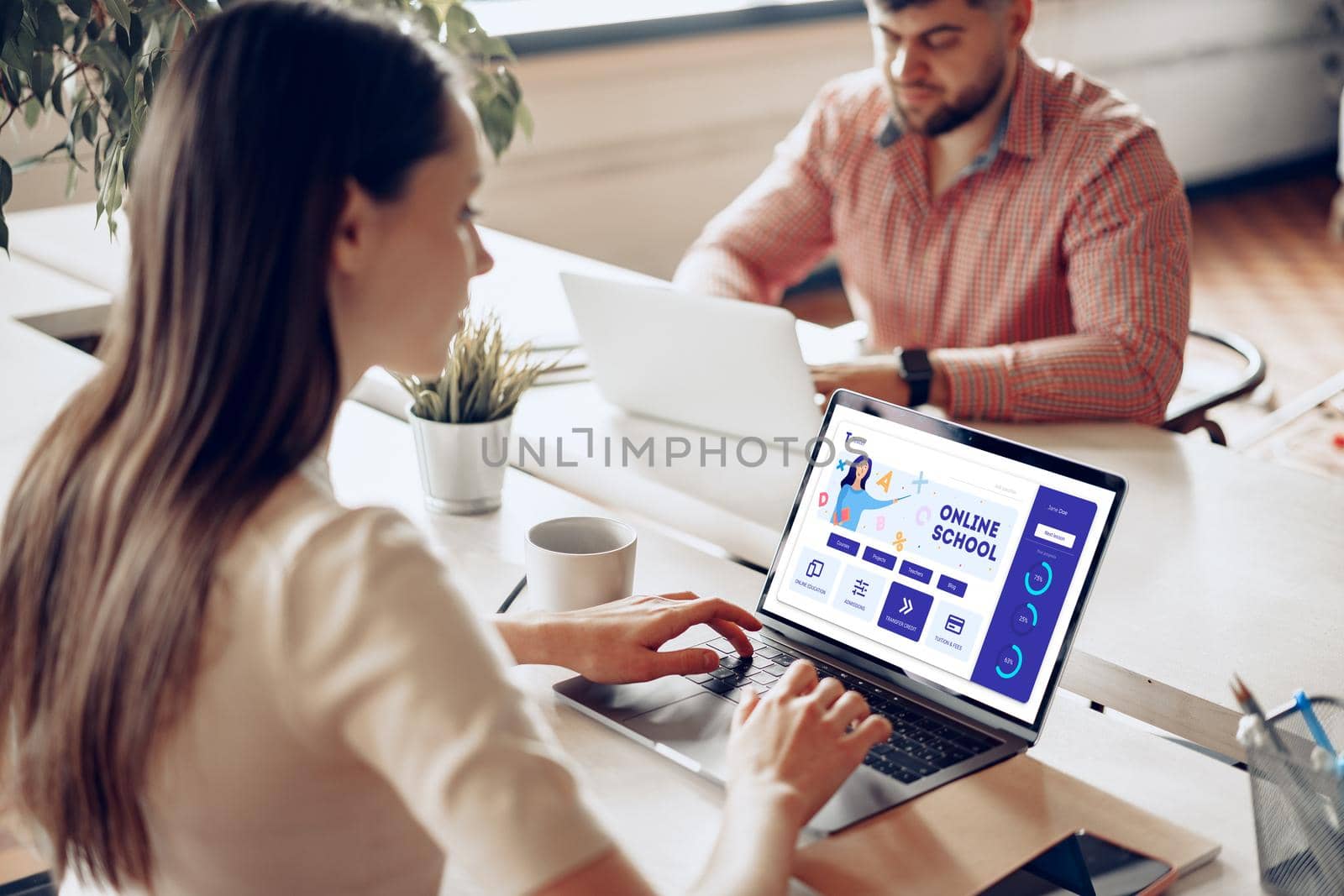 Male and female colleagues working at the table in office together