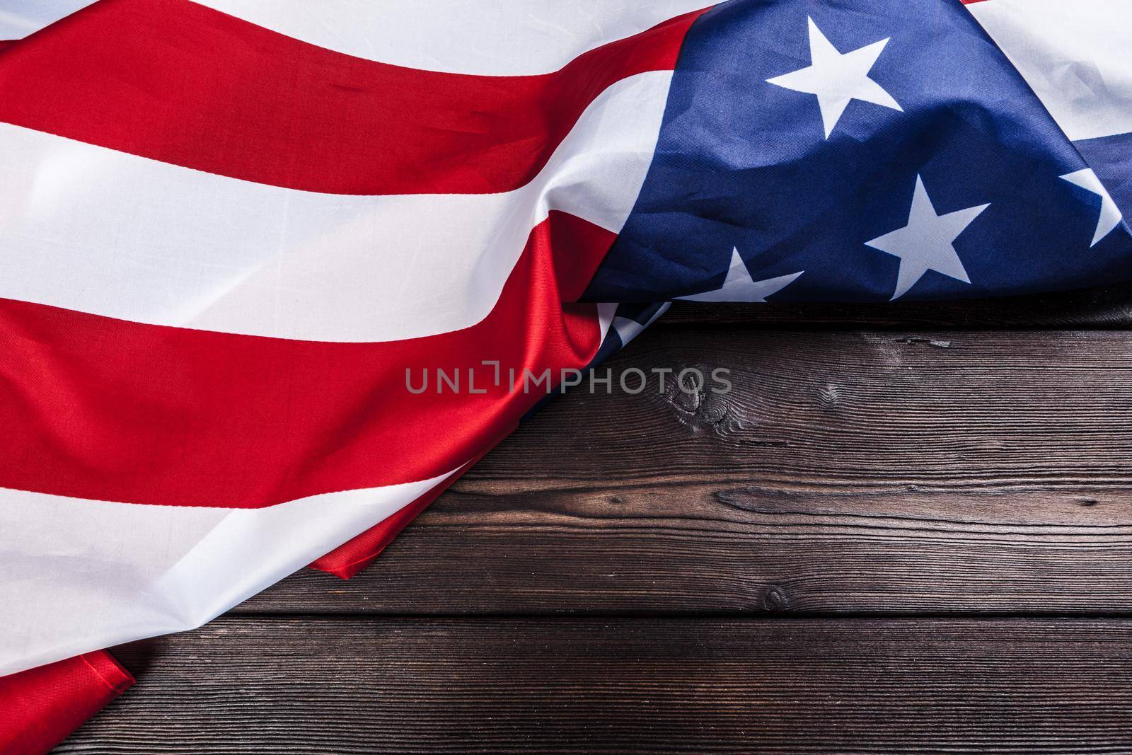 USA flag on dark wooden table background. Close up.