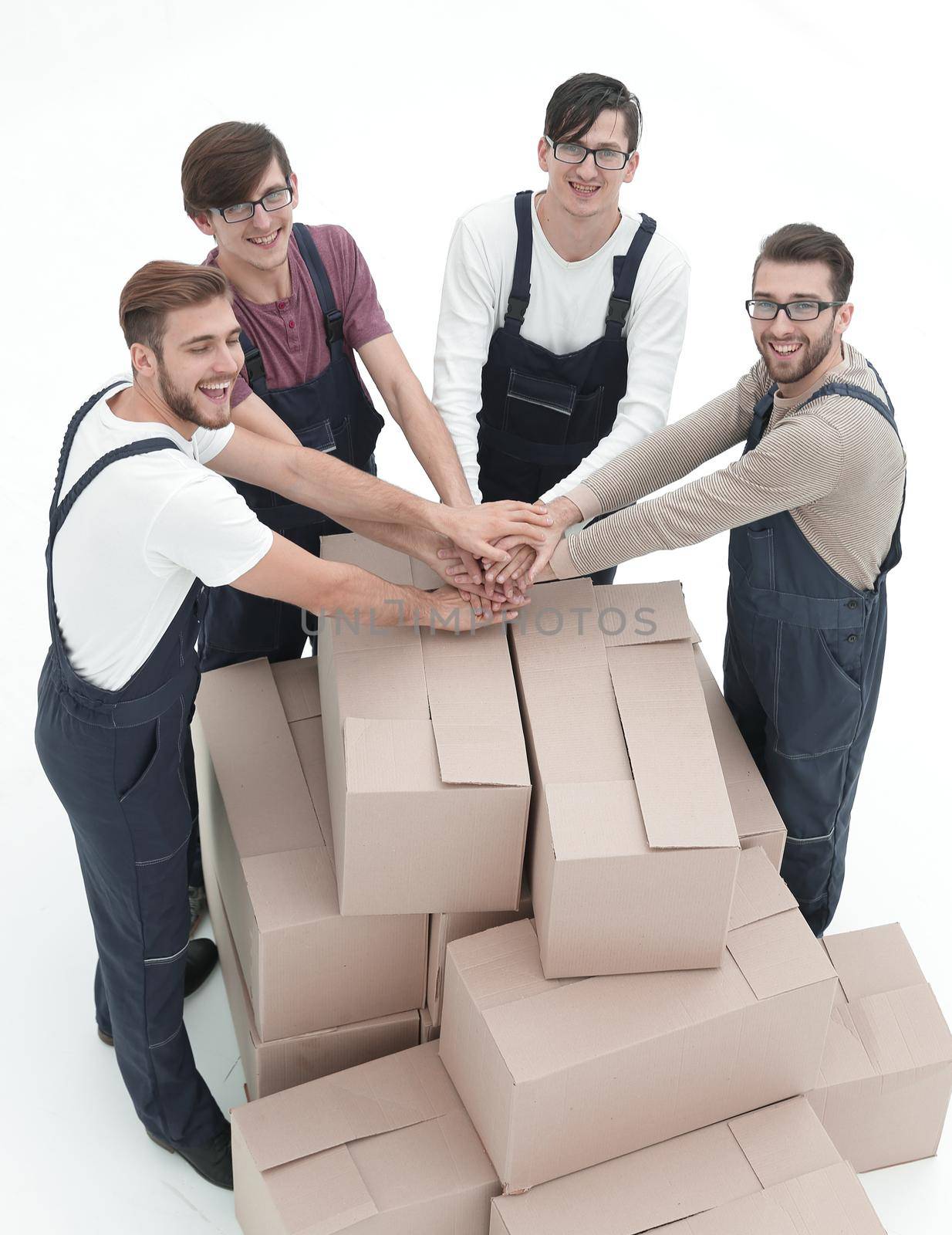 Cheerful movers leaning on stack of boxes isolated on white back by asdf