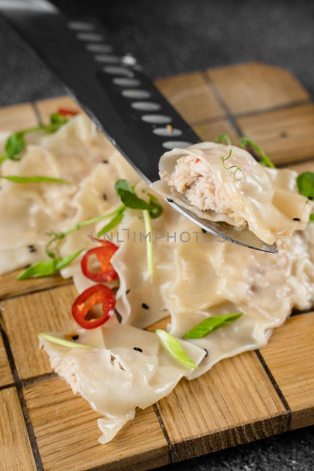 Jiaozi chinese dumplings named gyoza on wooden plate. Asian traditional fast food. Dough dish stuffed with meat and vegetables, less often only meat