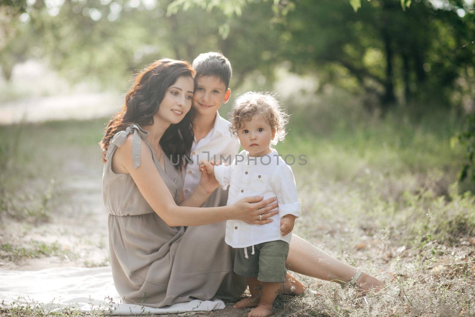 Happy young woman with children on wheat summer field. Happy motherhood. by Forewer