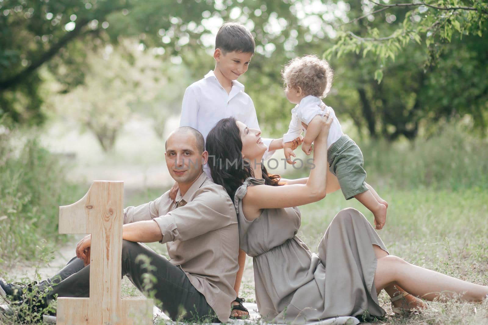 Happy young family with two children on wheat summer field. Adventure, travel, tourism, hike and people concept - happy family walking by Forewer