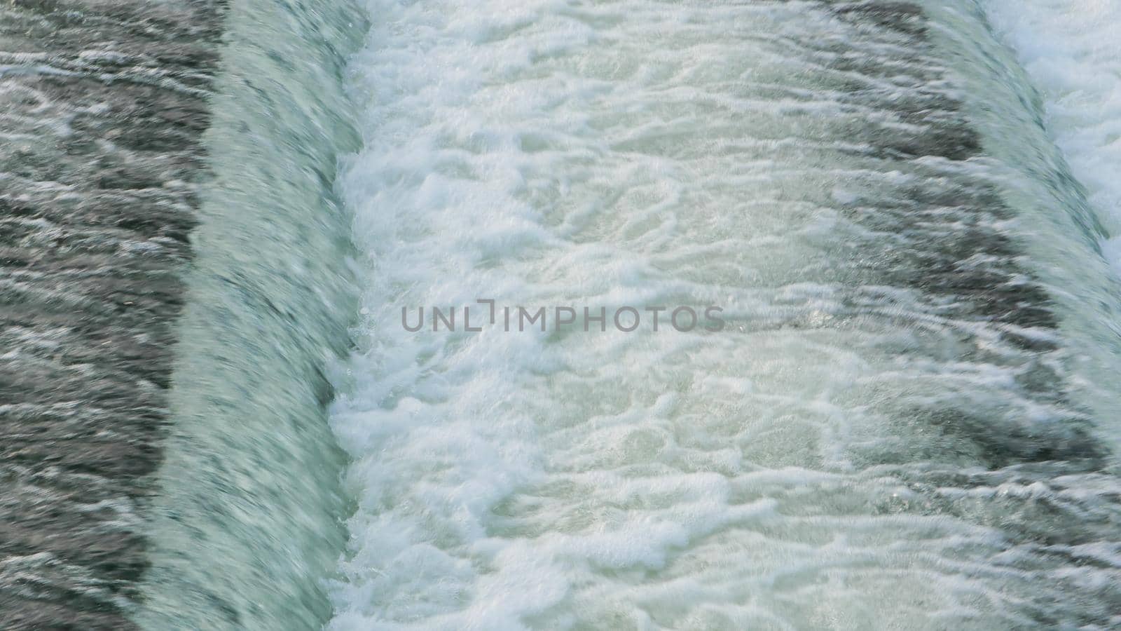 Close-up view of the water dam on the river. by gelog67