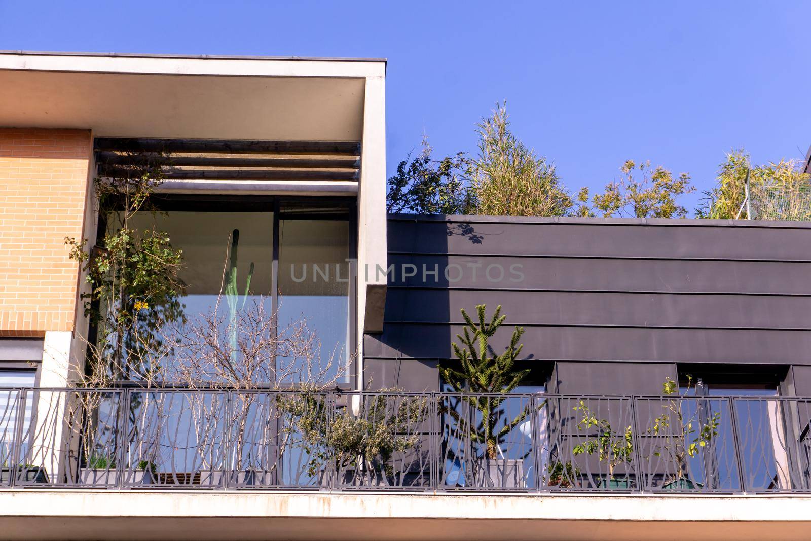 Parisian attic with panoramic windows and flowers in pots on the balcony on a sunny day