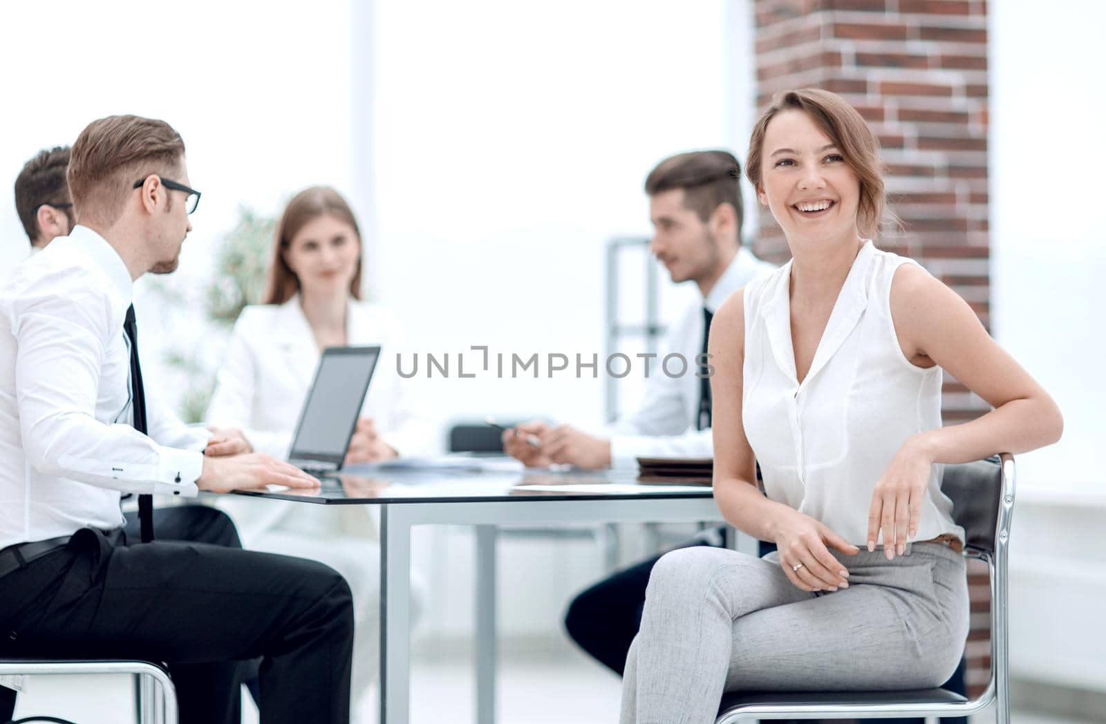 smiling employee and business team sitting at the Desk.the concept of teamwork