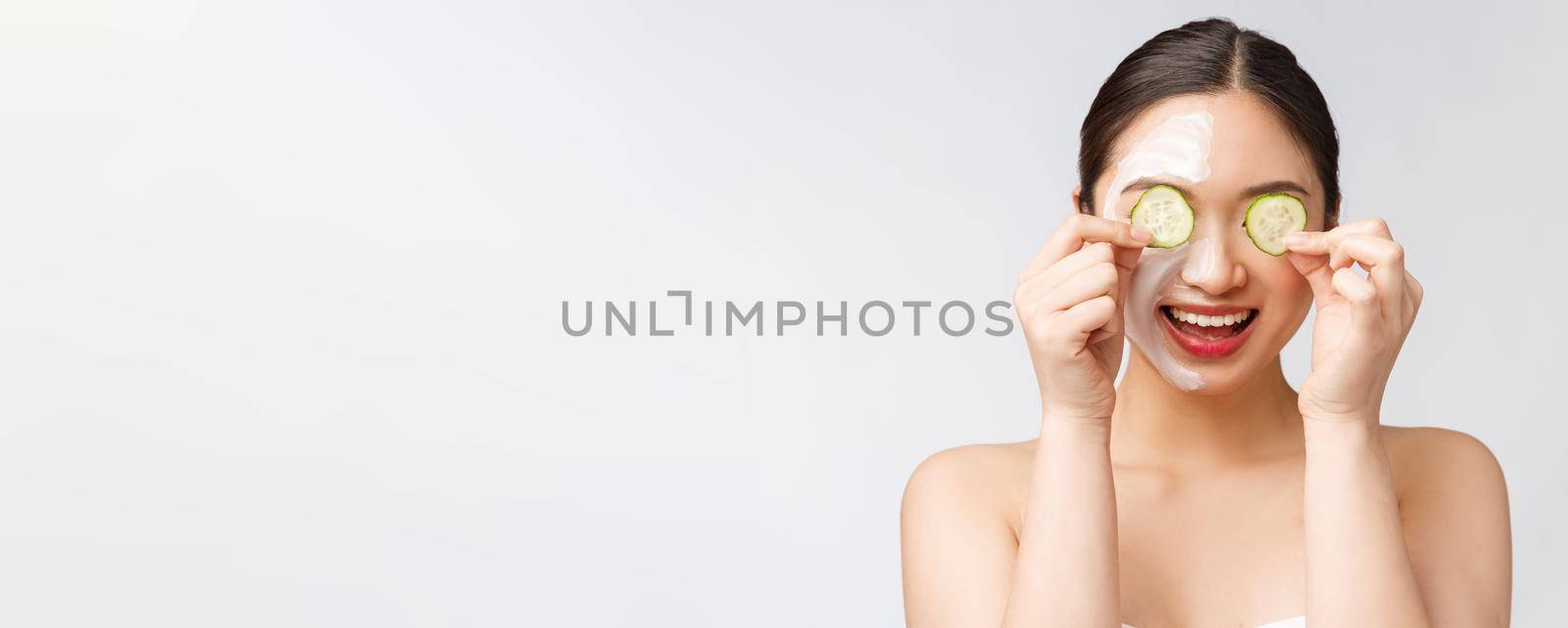 Beauty young asian women skin care image with cucumber on white background studio by Benzoix