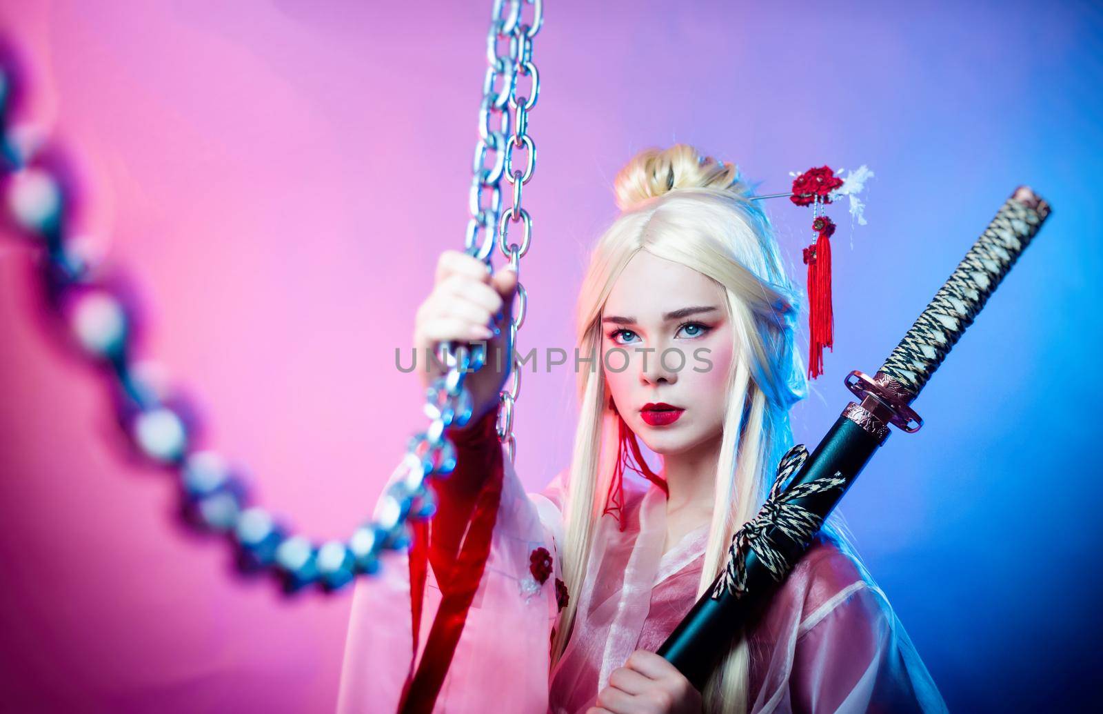 the woman in a geisha costume with a katana next to the chains
