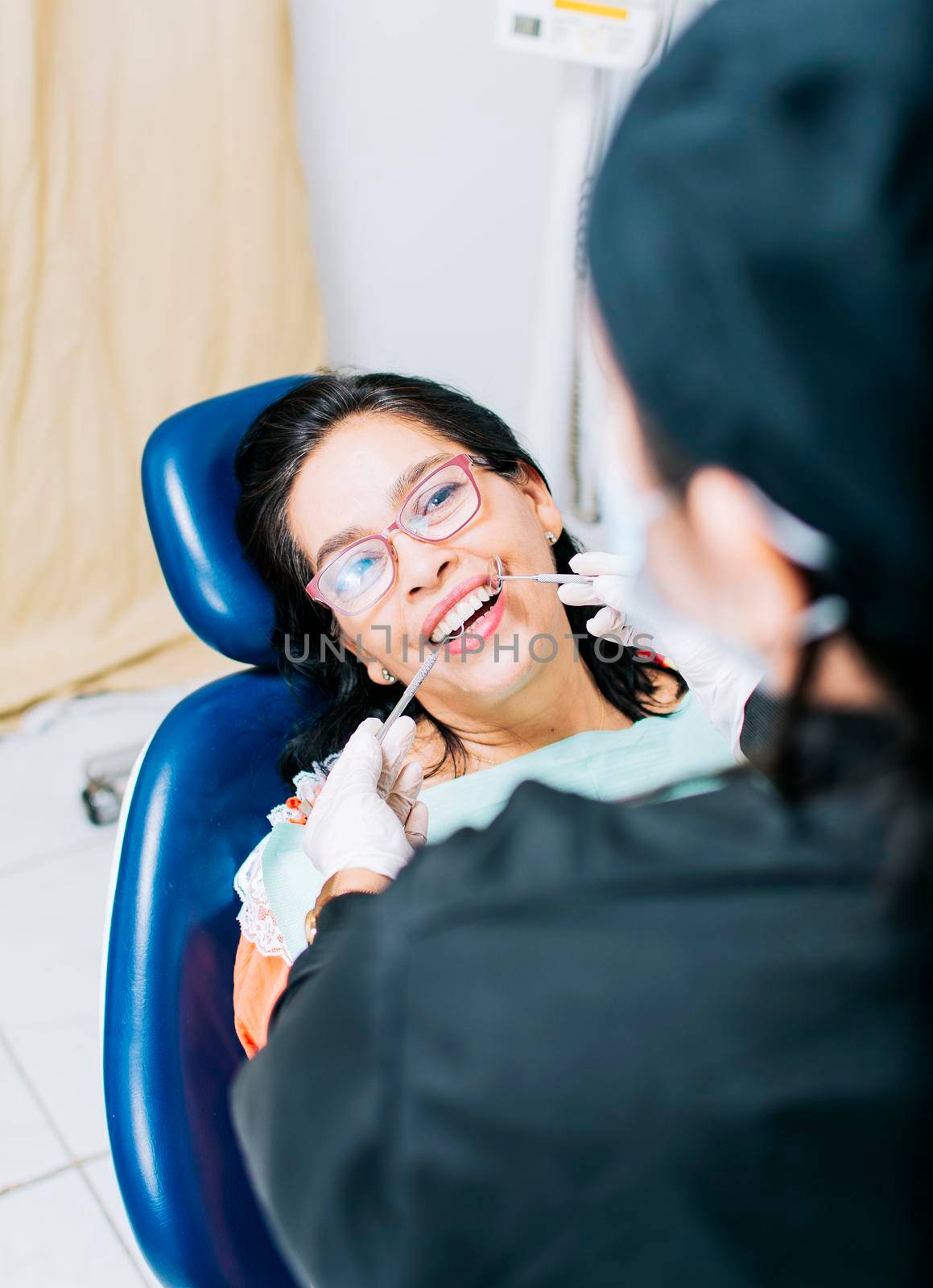 Patient checked by dentist, Top view of dentist doing dental checkup, close up of dentist with patient, dentist doing root canal treatment on patient