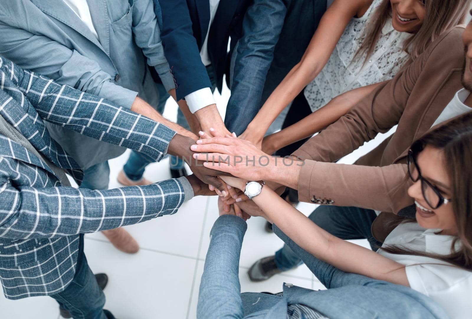 close up.Business people holding hands in a circle by asdf