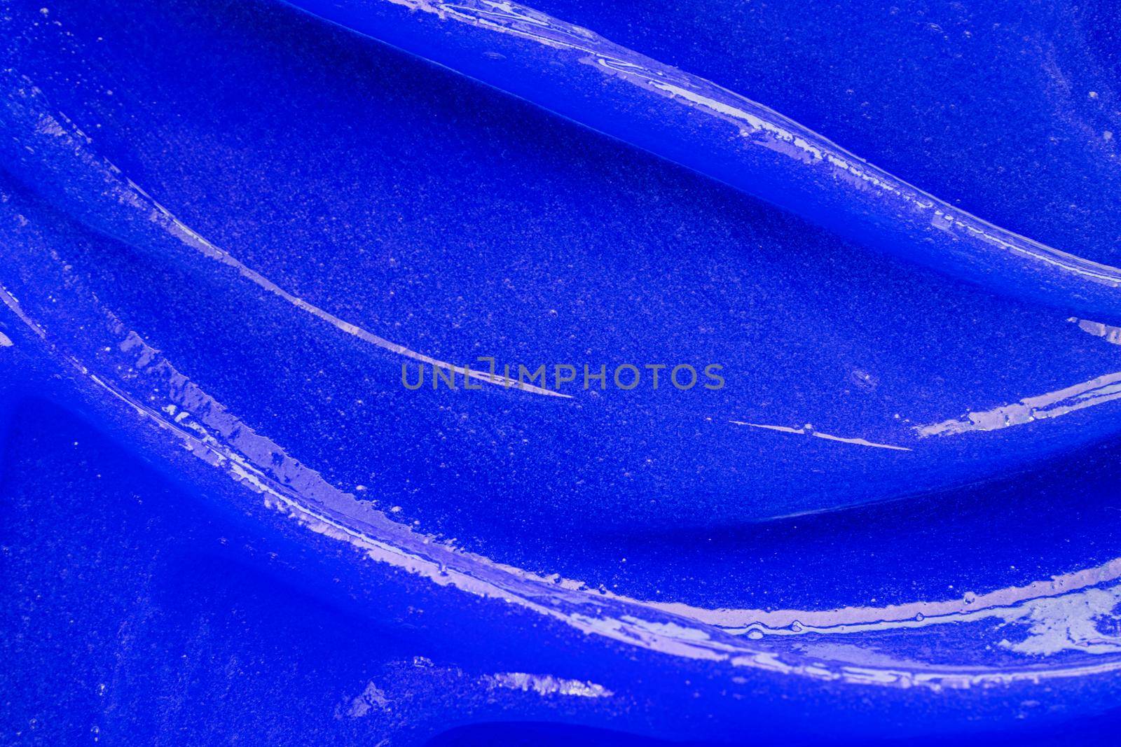 Blue gel texture. Cosmetic clear liquid cream smudge. Skin care product sample closeup. Toothpaste or wax by photolime