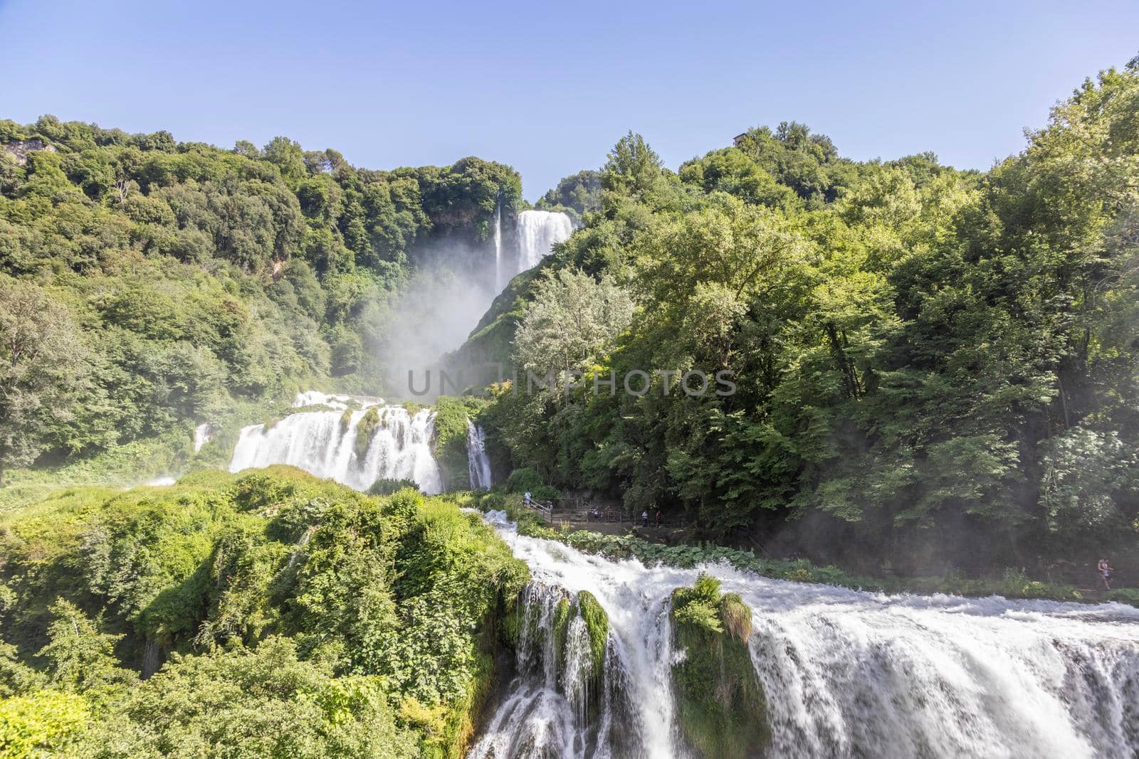 Marmore waterfall in Umbria region, Italy. Amazing cascade splashing into nature with trees and rocks.