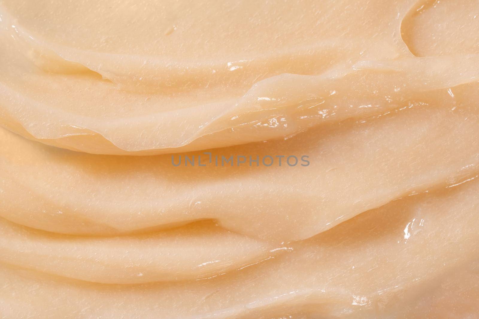 Hair conditioner cream background. Yellow cosmetic lotion moisturiser sample closeup. Body care balm, retinol serum, shampoo wavy texture. Skincare mask smear, creamy cleanser product by photolime