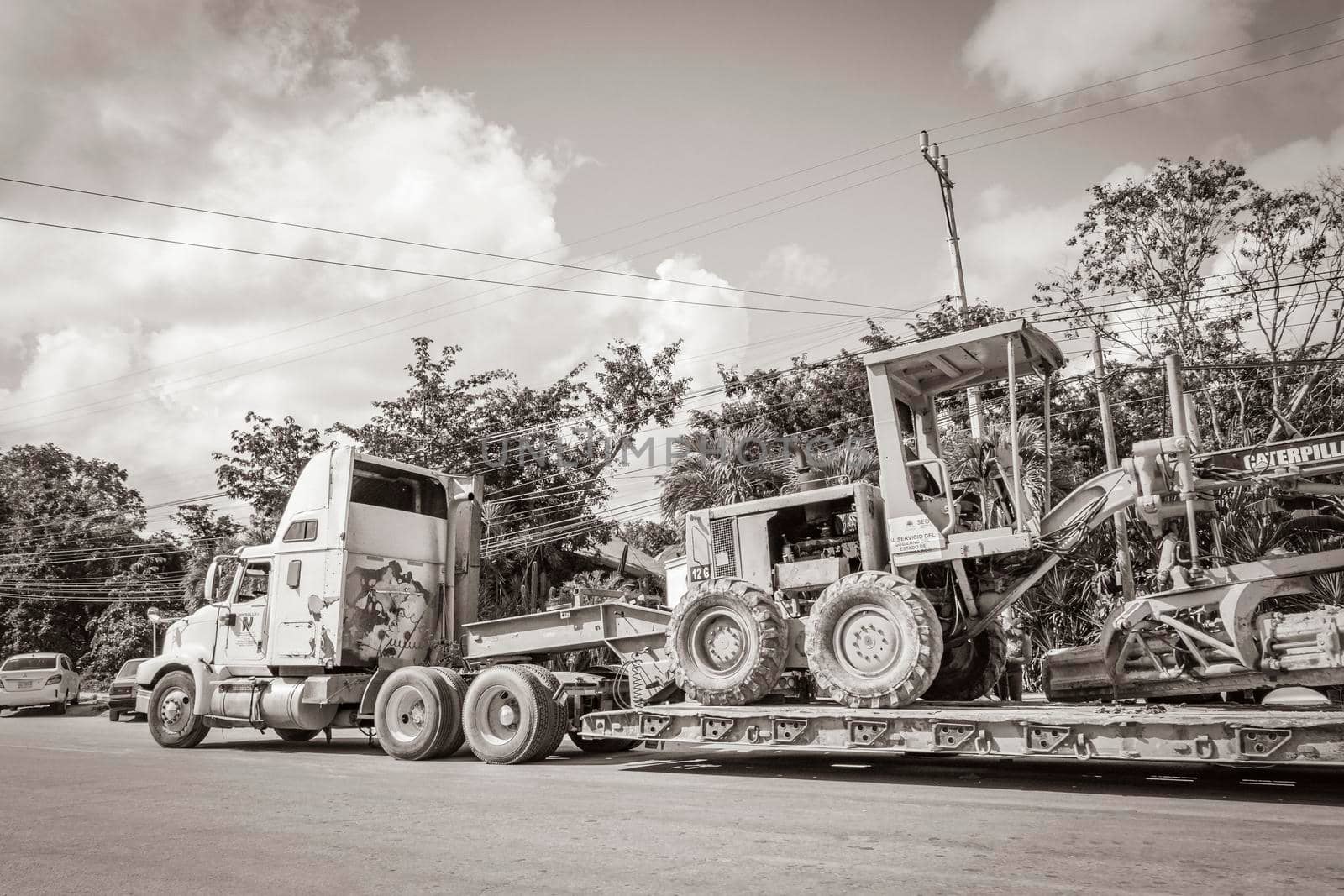 Trucks dump truck and other industrial vehicles in Tulum Mexico. by Arkadij