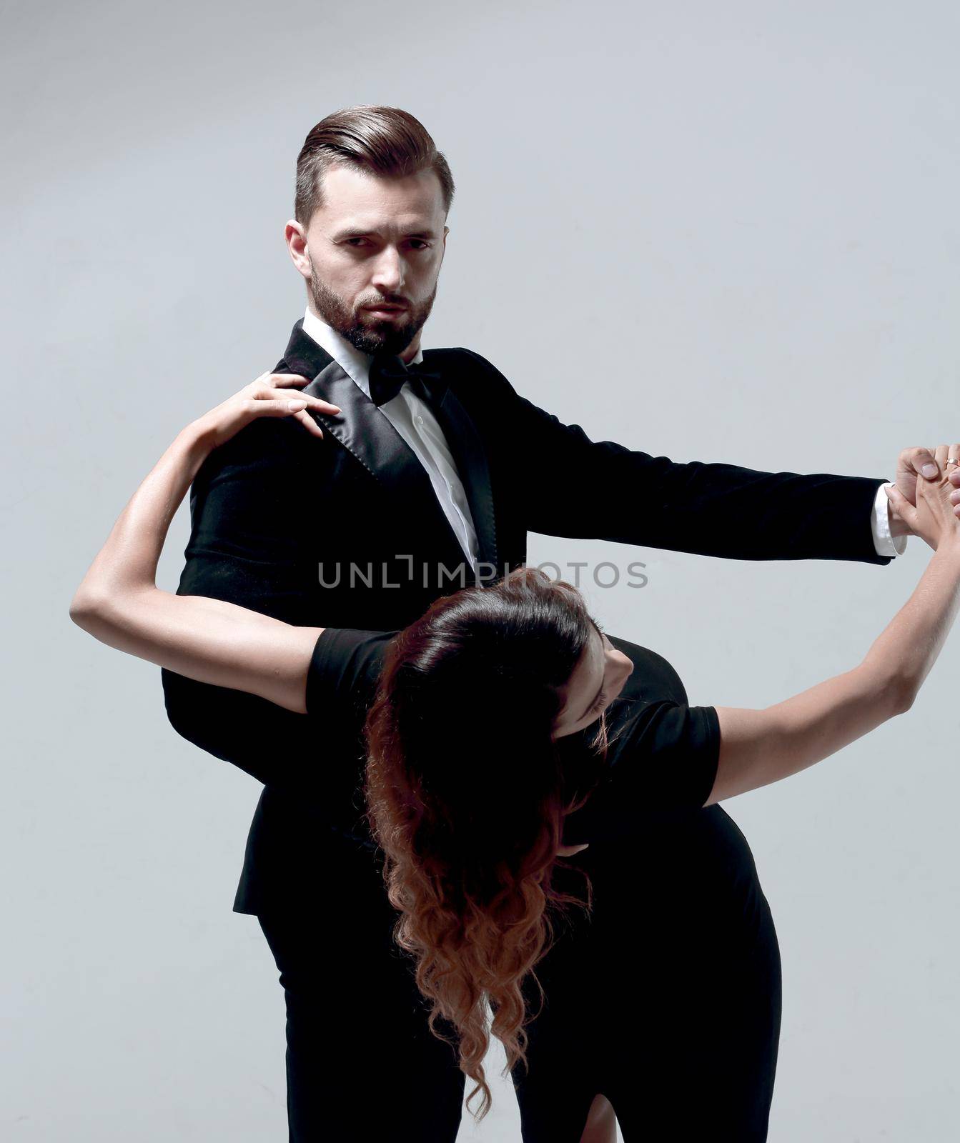 Portrait Of Young Couple Dancing Over Grey Background by asdf