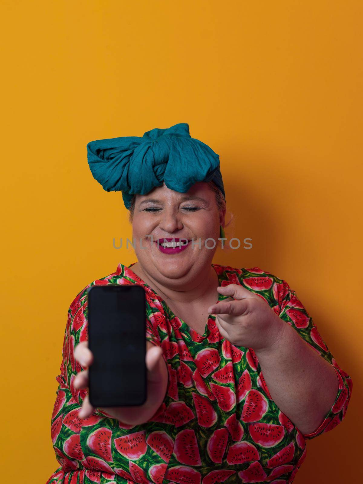 Blonde plus size woman having conversation talking by smartphone over yellow background smiling with an idea or question pointing finger with happy face, number one by dotshock