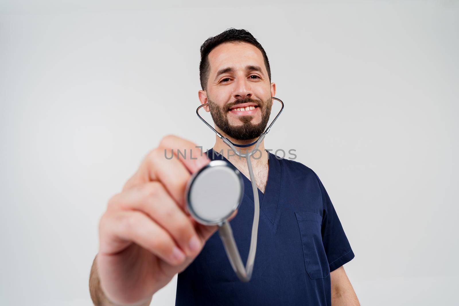 Handsome bearded arab doctor with phonendoscope does auscultation to patient. Medical therapy and treatment. Research and testing for coronavirus covid-19