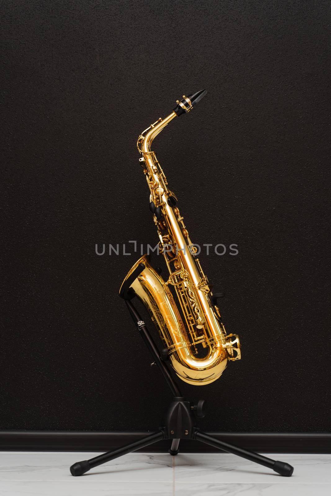 Sax musical instrument for play jazz. Saxophone musician instrument on stand on black background