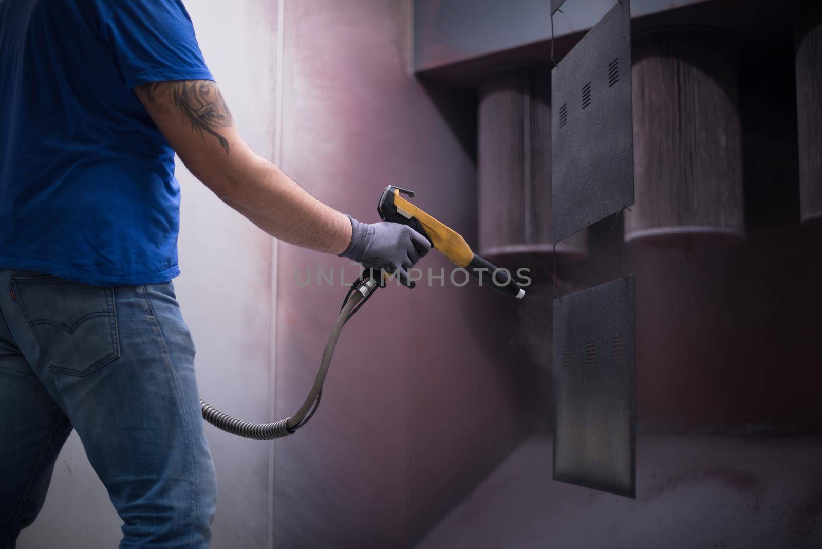 The painter paints the iron element. Industrial painting parts. Metal designs. High-quality photo