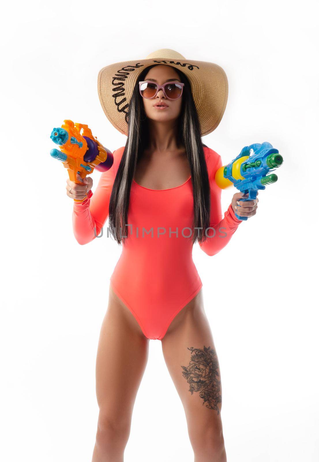 brunette girl with a water gun in summer clothes, slim and sexy by Rotozey