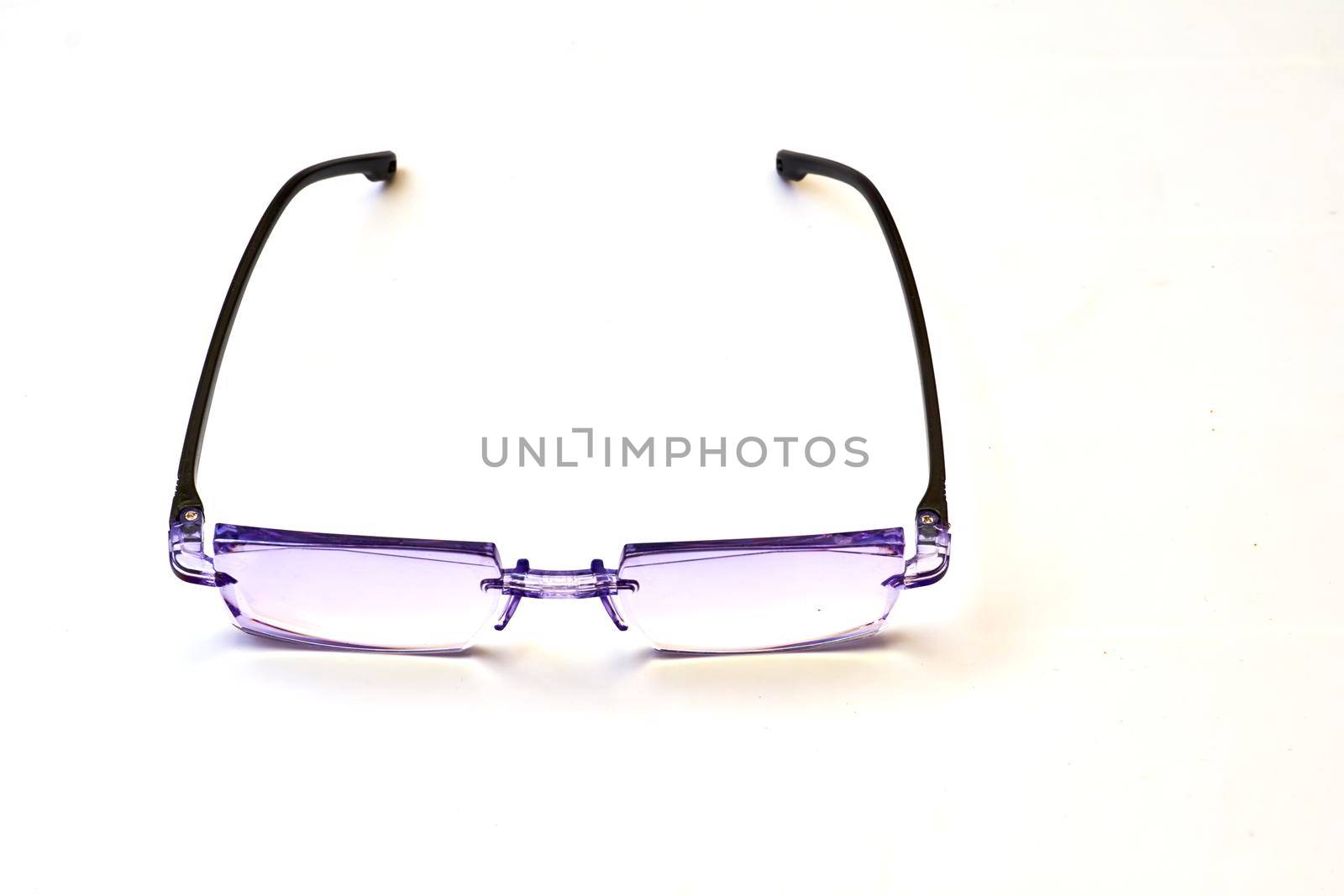 a pair of lenses set in a frame resting on the nose and ears, used to correct or assist defective eyesight or protect the eyes.