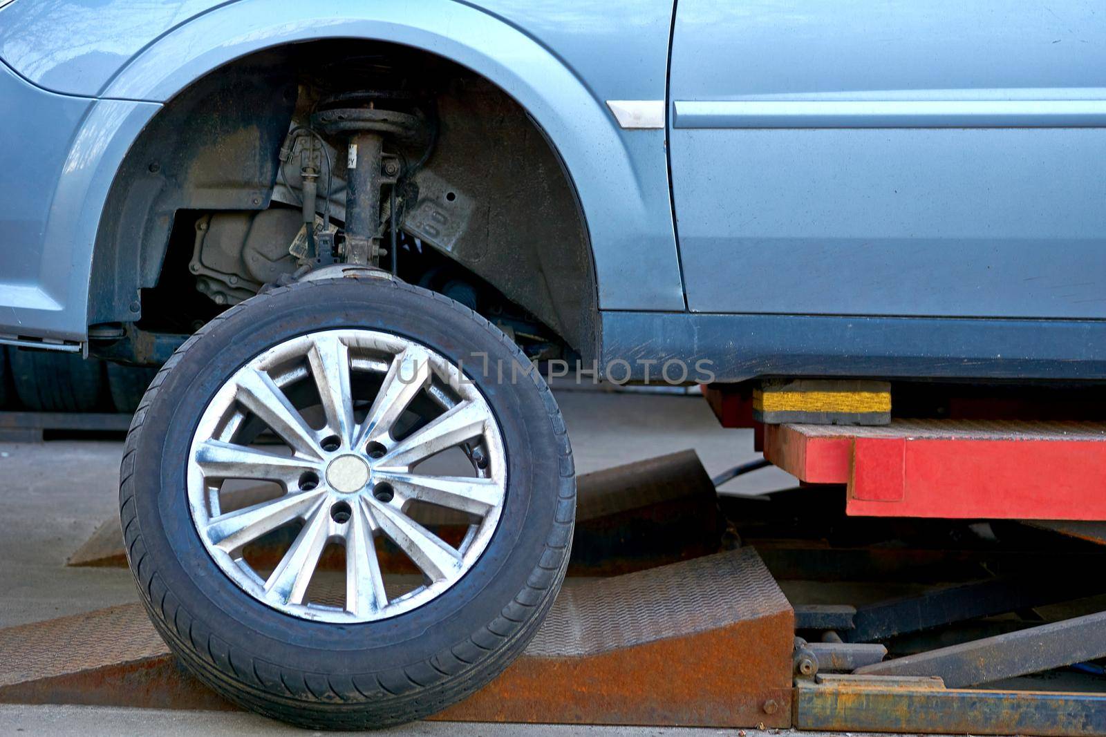 Replacing a car wheel at a tire station. a rubber covering, typically inflated or surrounding an inflated inner tube, placed around a wheel to form a flexible contact with the road.