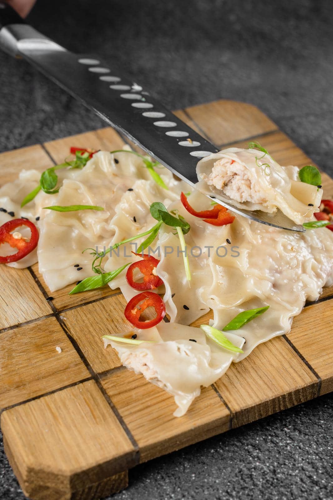 Jiaozi chinese dumplings named gyoza on wooden plate. Asian traditional fast food. Dough dish stuffed with meat and vegetables, less often only meat