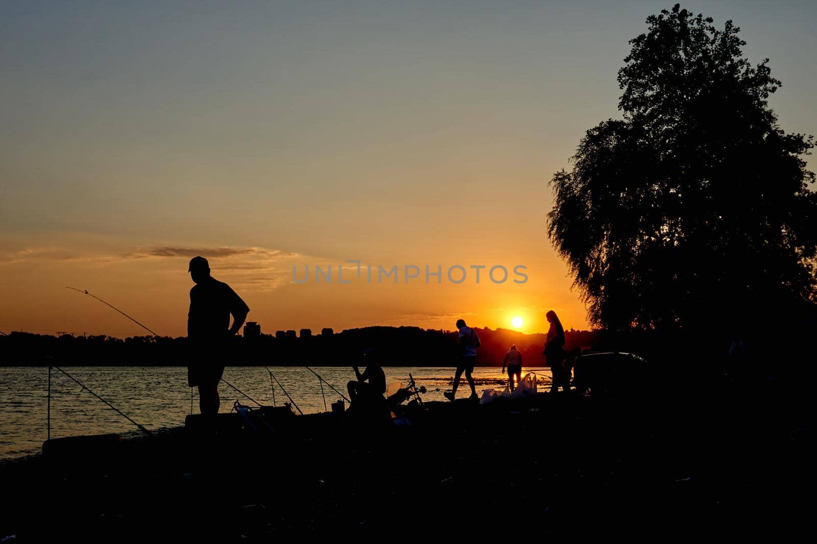 Fishermen at sunset are fishing in the river.Such a hobby by jovani68