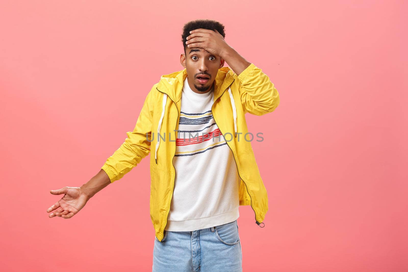 Dude where is my car. Portrait of shocked frustrated and confused handsome stylish young african american male student in yellow evening jacket holding hand on forehead shrugging being clueless. Emotions concept