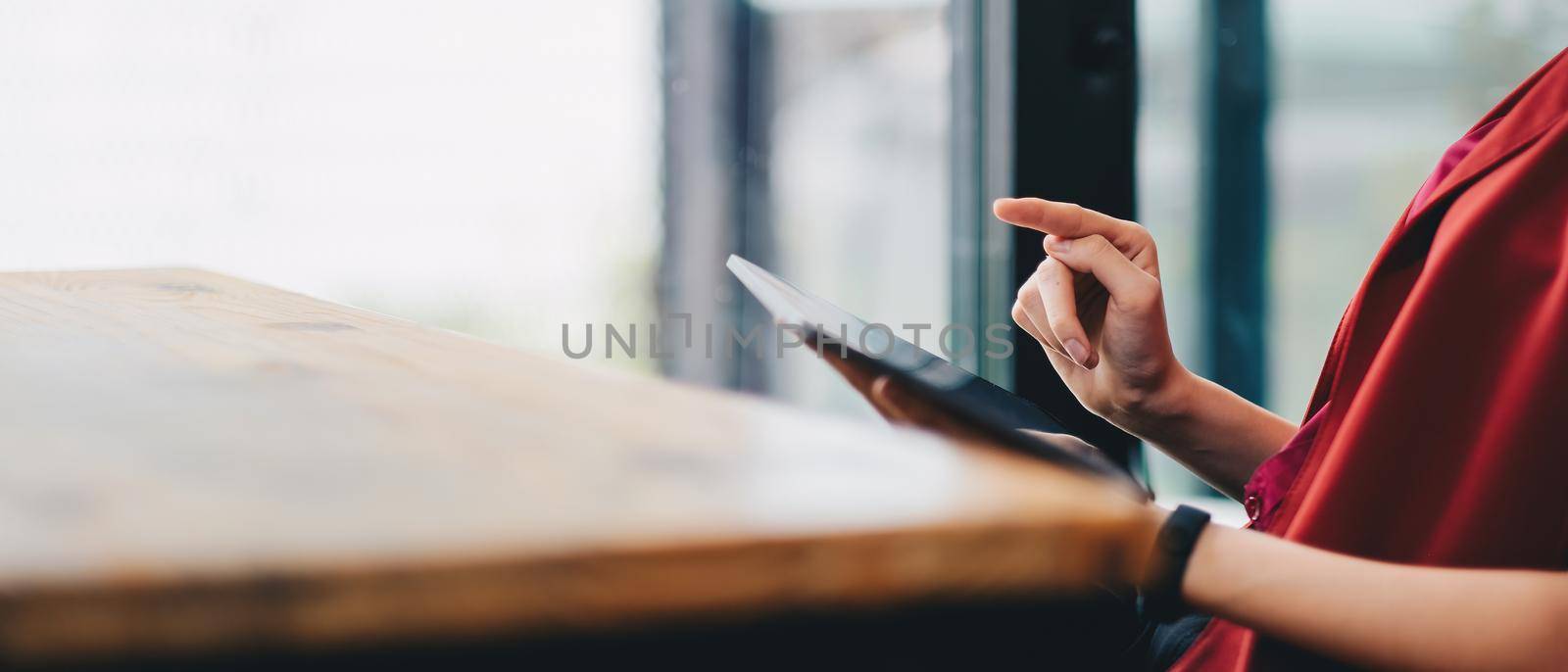 Close up hand of woman using digital tablet with touch screen.