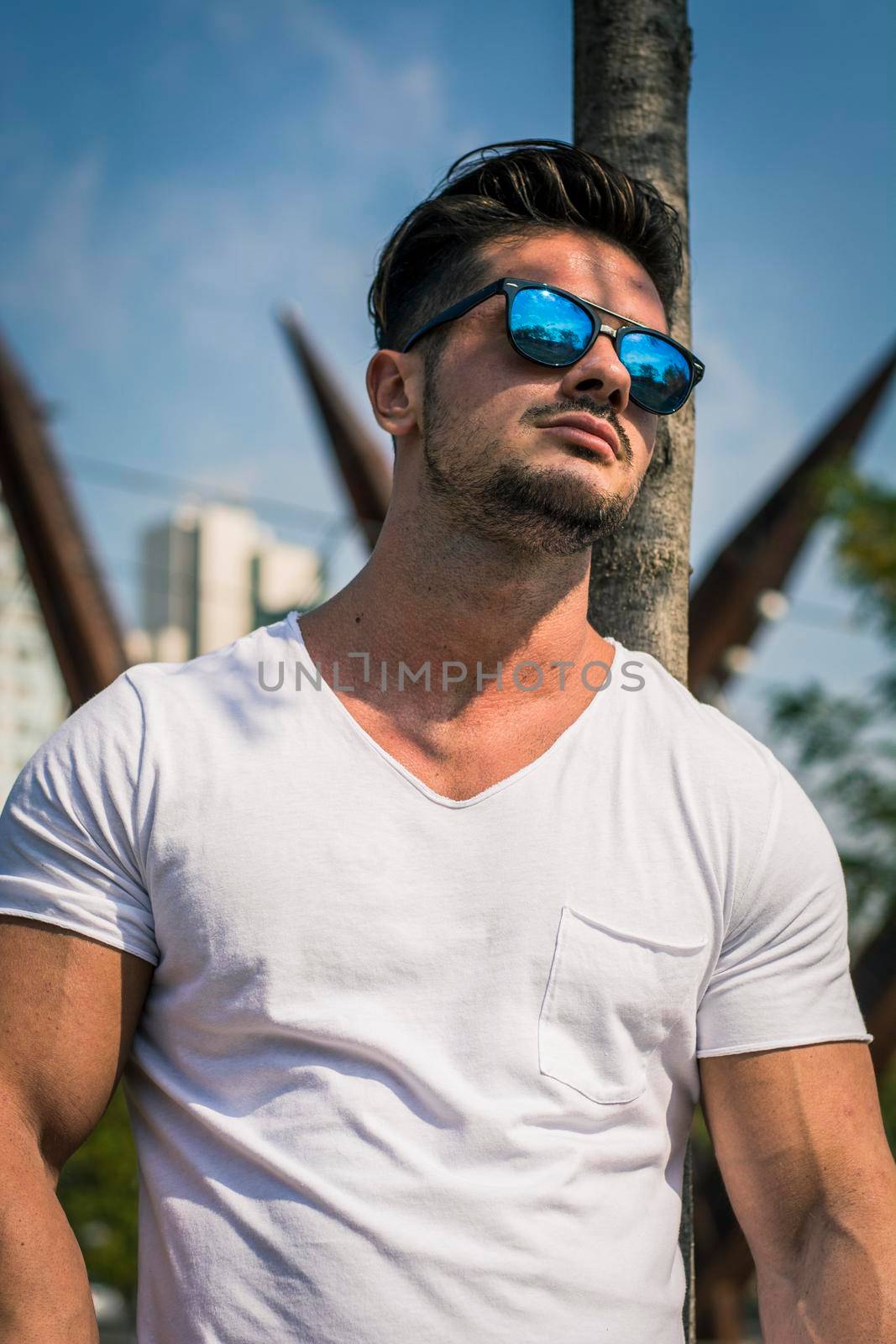 Man in urban setting in front of big metal structure by artofphoto