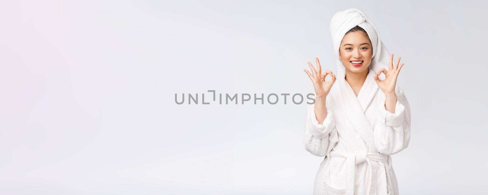 beauty asian woman ok gesture for good facial product. isolated on white background. beauty and fashion concept