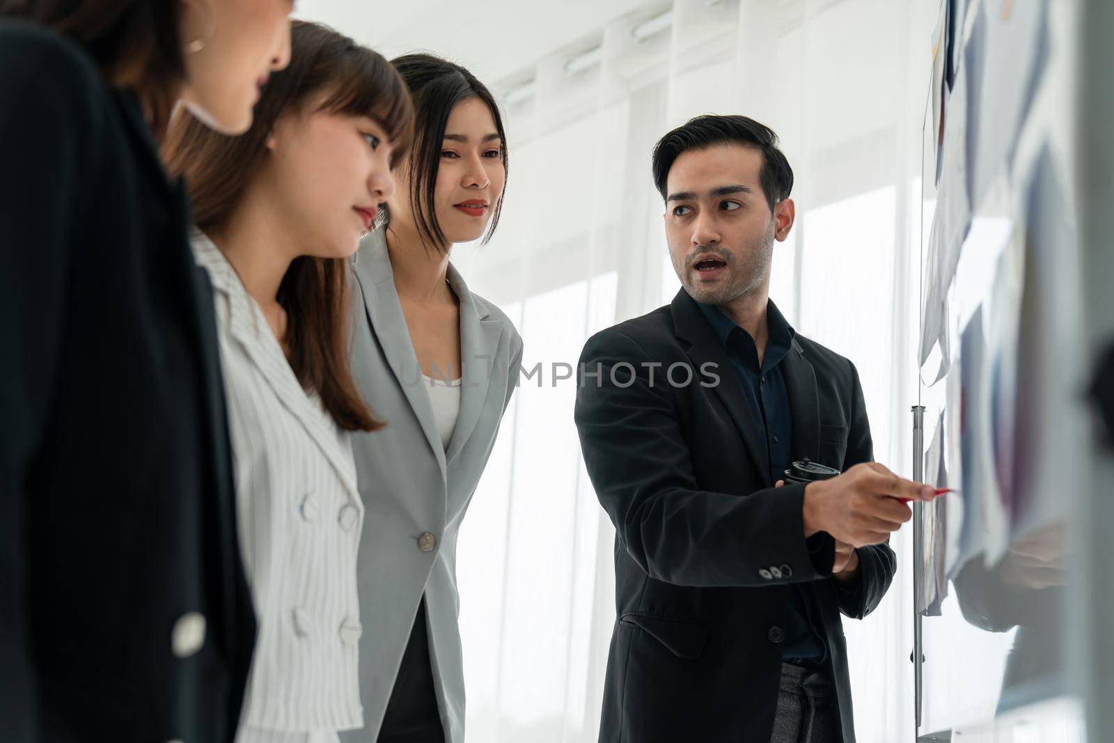 Business people proficiently discuss work project while sitting in circle by biancoblue