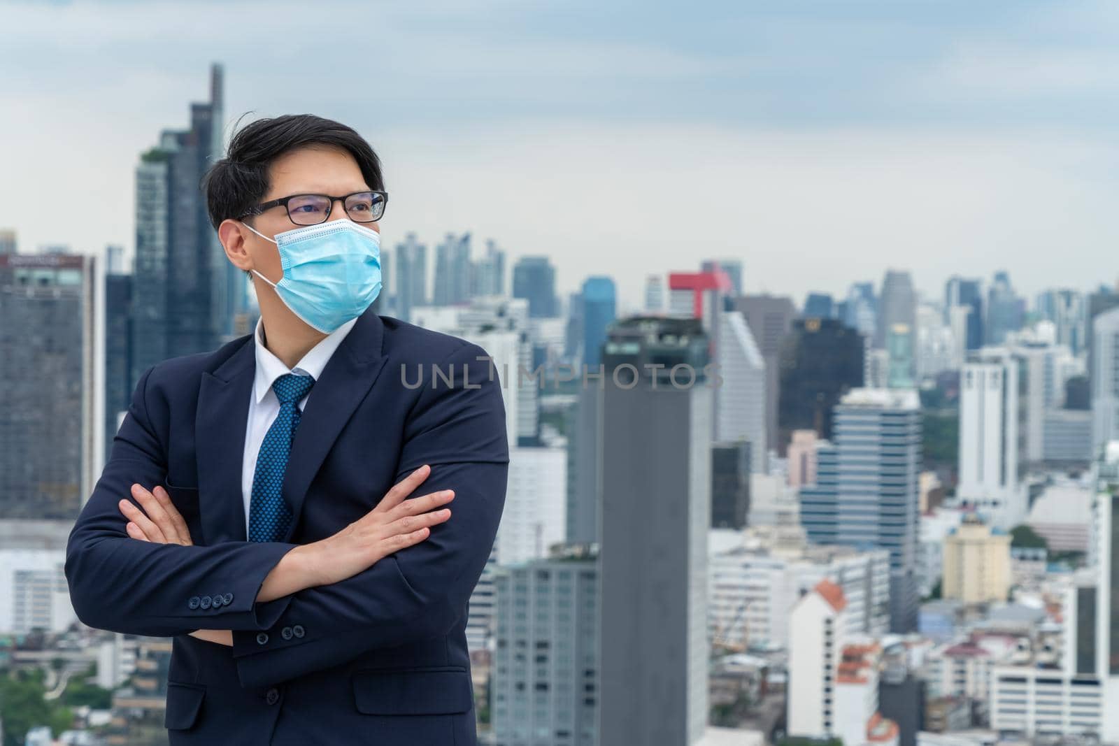 Young office worker with face mask quarantine from coronavirus or COVID-19. by biancoblue