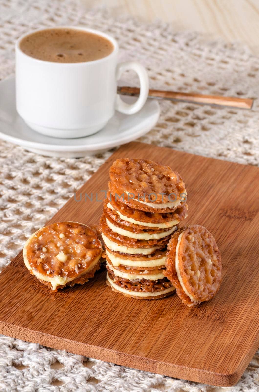 Caramel Florentines cookies on a wooden cutting board. From series Italian Desserts