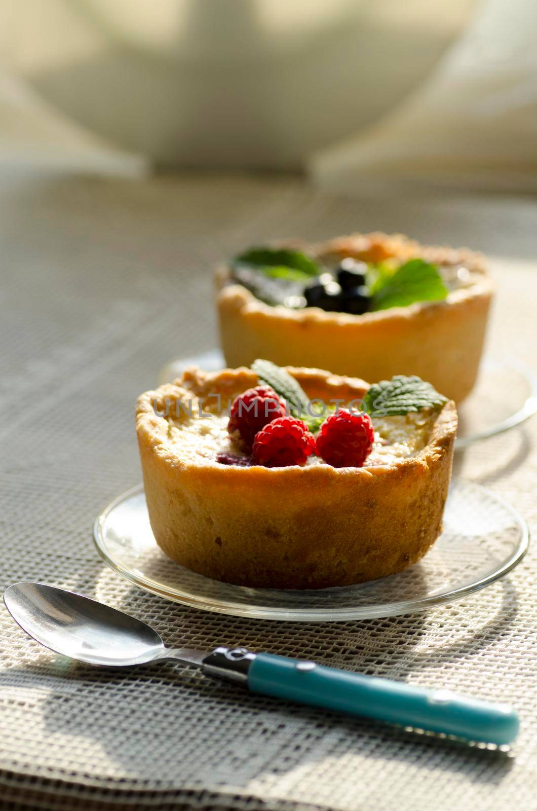 Mini berry tarts decorated with raspberries and blueberries